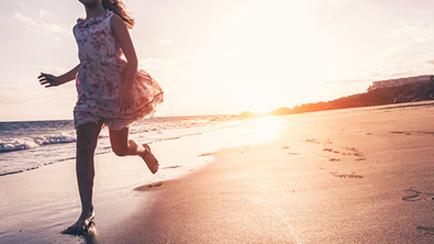 Mädchen bei Sonnenuntergang am Meer