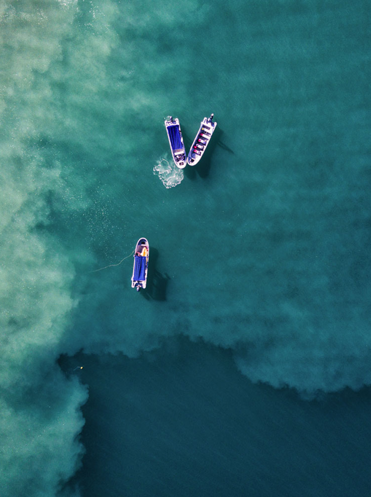 Aerial drone photo of three fishing boats in the Pacific Ocean, off the coast of Costa Rica