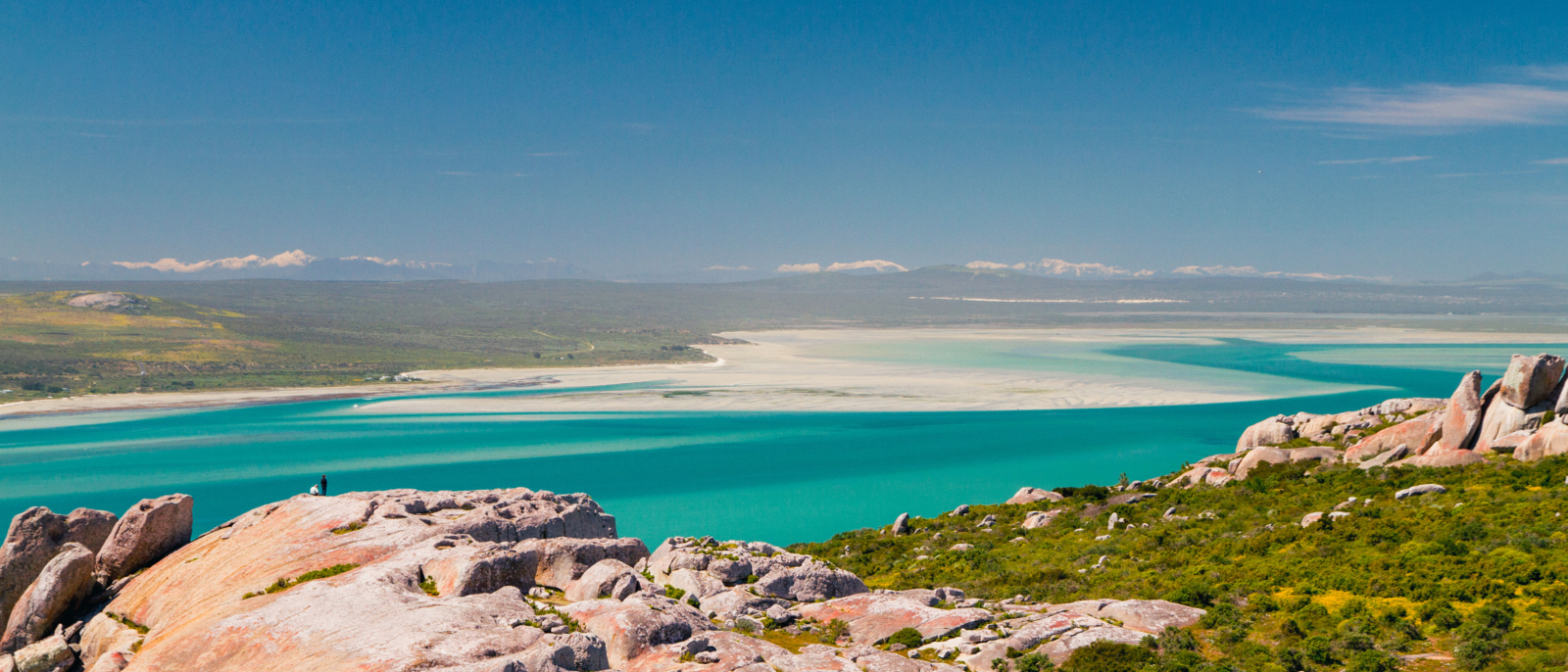 01 The snow-capped Cederberg mountains and turquoise waters of the Langebaan Lagoon. West Coast National Park, South Africa