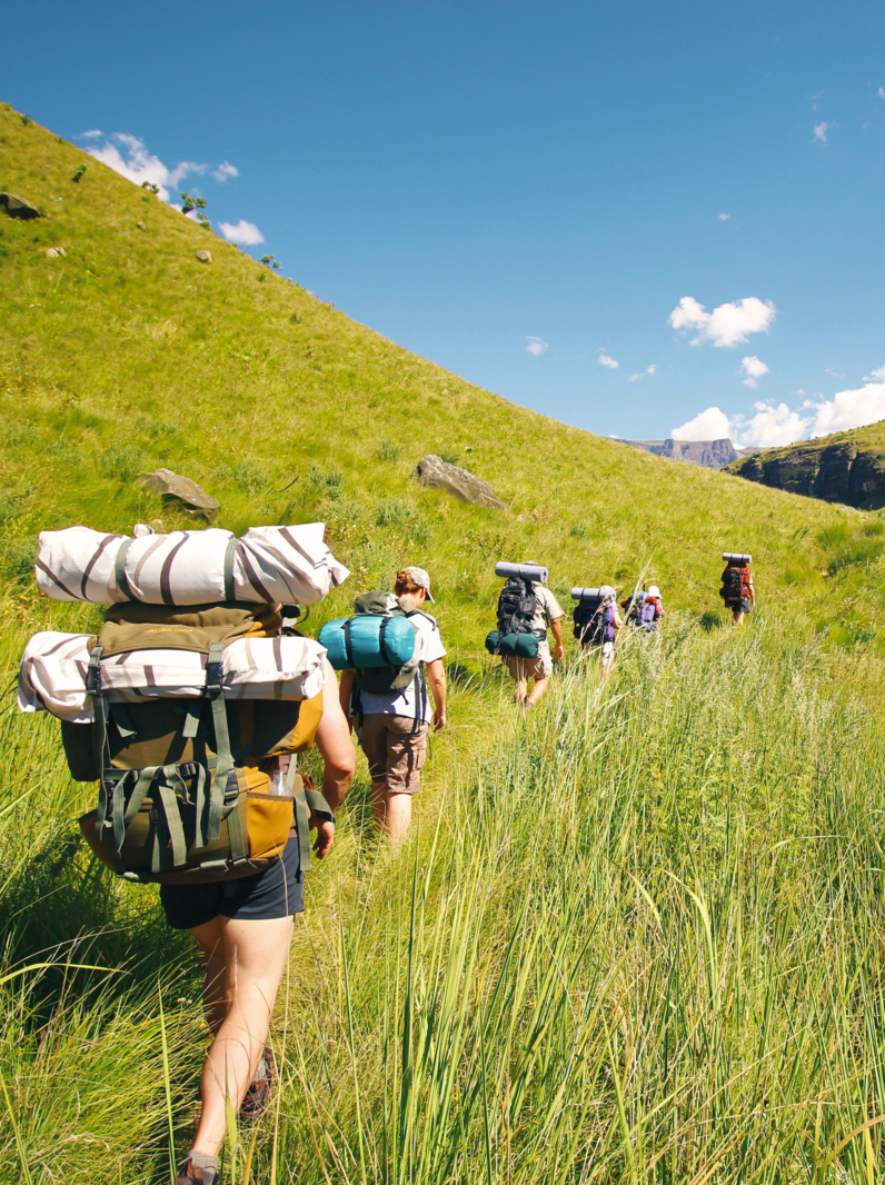 02 People hiking mountains rucksack boots camping Drakensberg grass hills sky