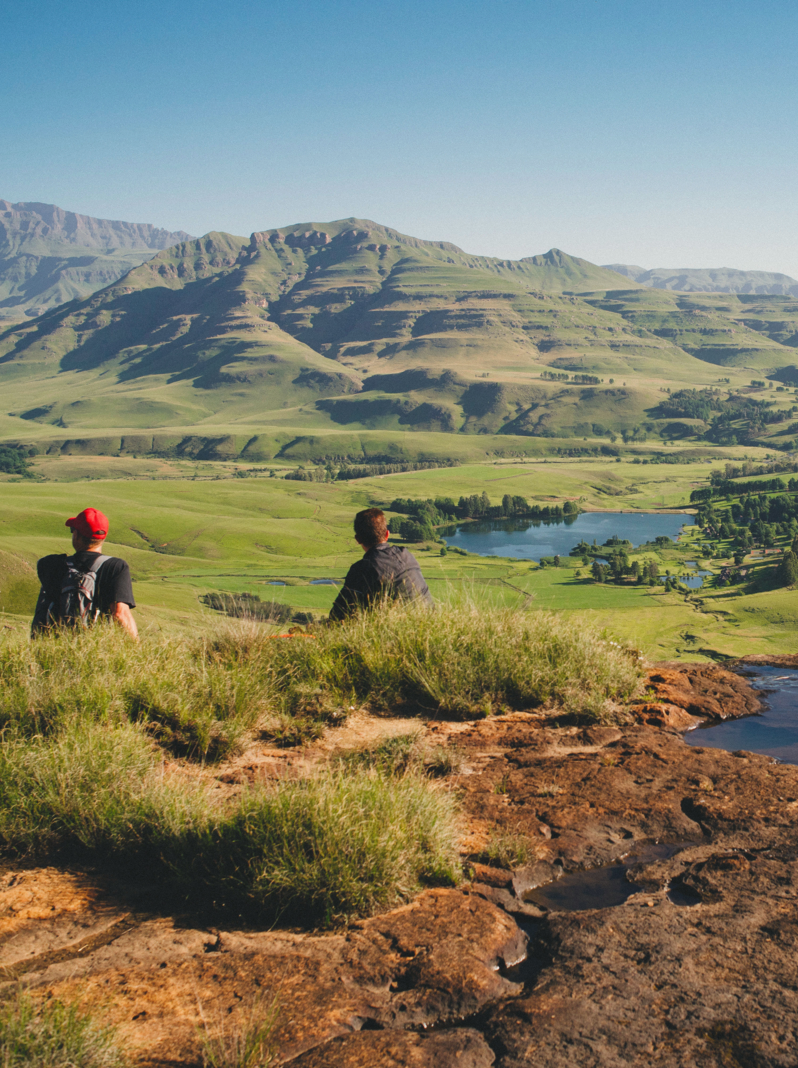01 Hikers having a rest in the mountains of the DRakensberg overlooking the southern drakensberg valley