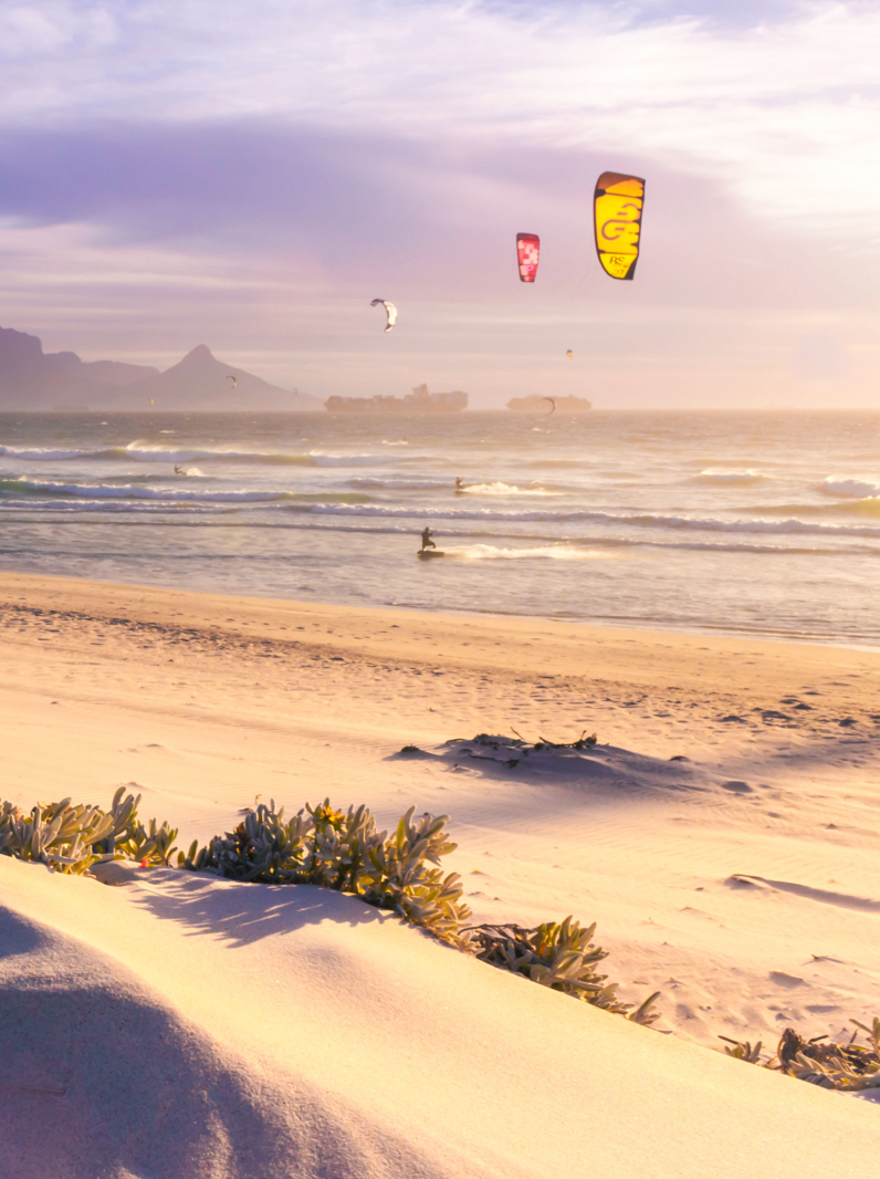 02 View of Table Mountain from Milnerton Beach at sunset, with kite surfers in the water, Cape Town, South Africa