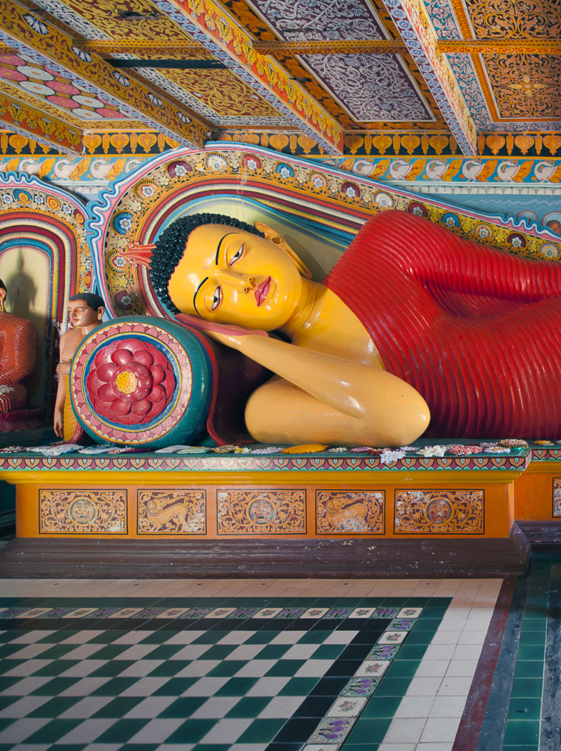 The enormous and colourful Reclining Buddha, in the Isurumuniya Temple of the Two Lovers at Polonnaruwa, Sri Lanka