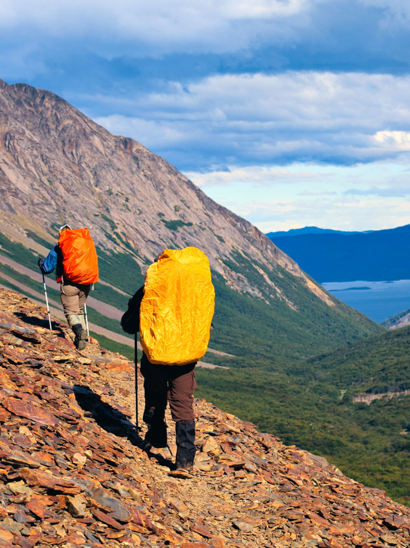 Two backpackers on the trial high in the Fuegian Andes of Tierra del Fuego, Argentina. The Beagle Channel is visible in the background