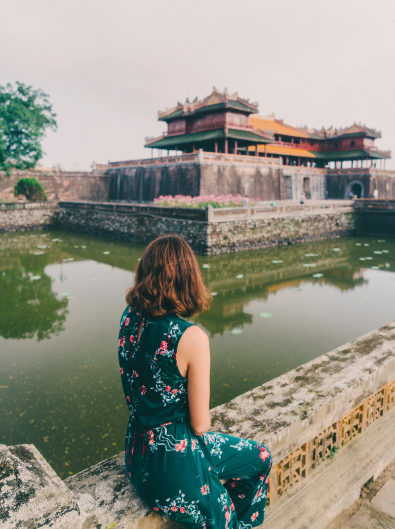 Young Caucasian woman walking in Hue Forbidden city