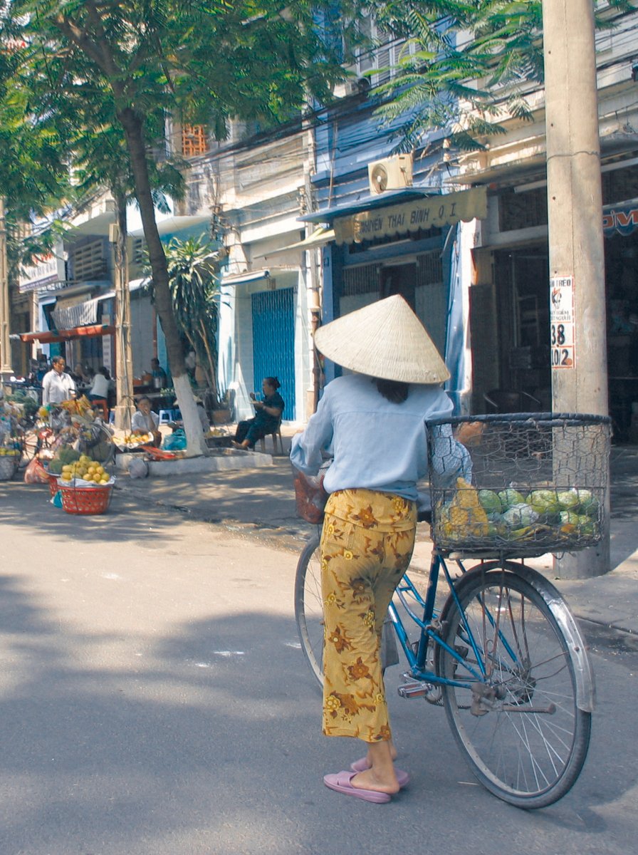 Woman with a bike in Saigon, Vietnam