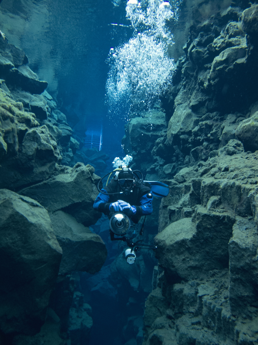 Scuba Diving at Silfra, Iceland in Dry Suits at the Continental Divide at the Þingvellir National Park in Iceland.