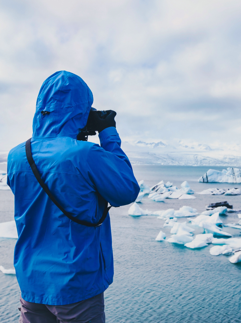nature travel photographer, person taking photo of arctic icebergs in Iceland