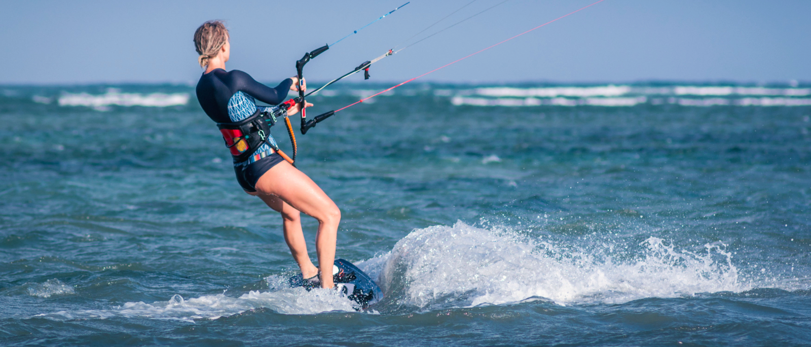 kiteboarder kitesurfer woman athlete performing kitesurfing kiteboarding jumping