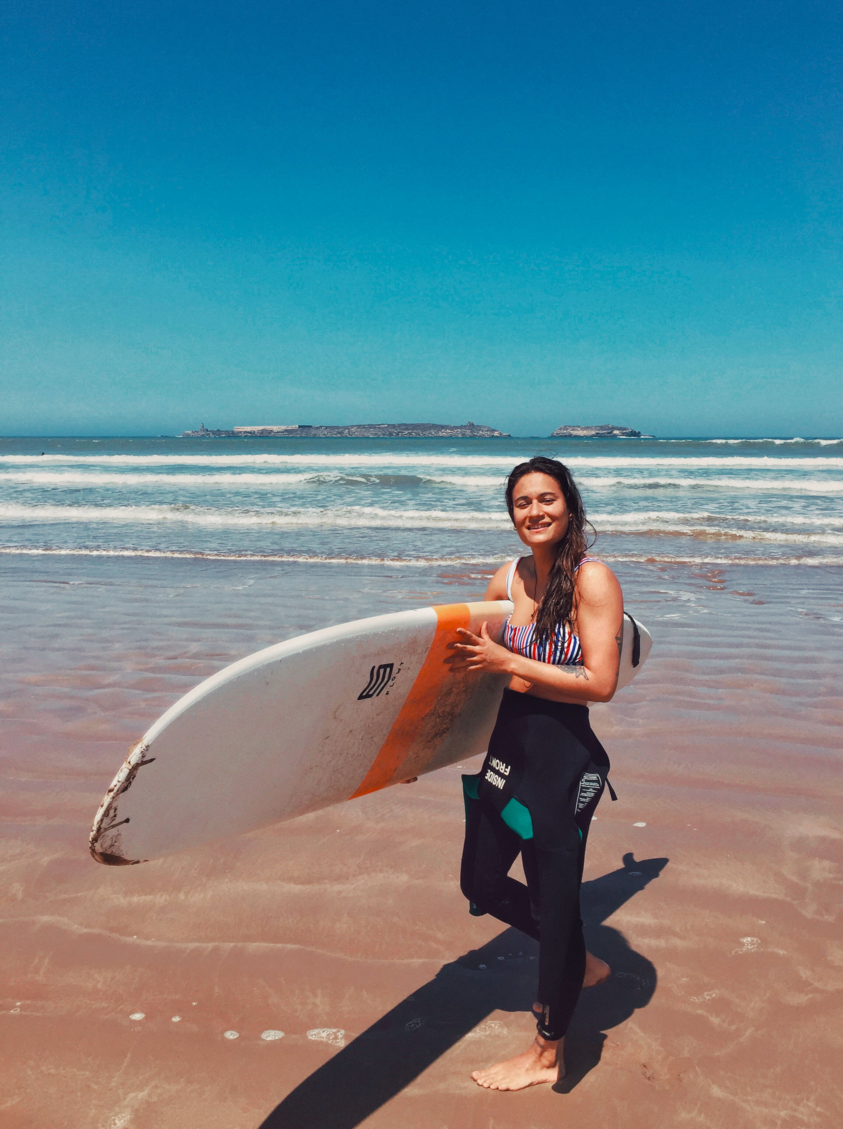 girl on the beach with surfboard