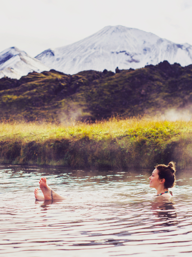 Girl in a hot spring in Iceland Landmannalaugar. Relaxing in a natural hot bath