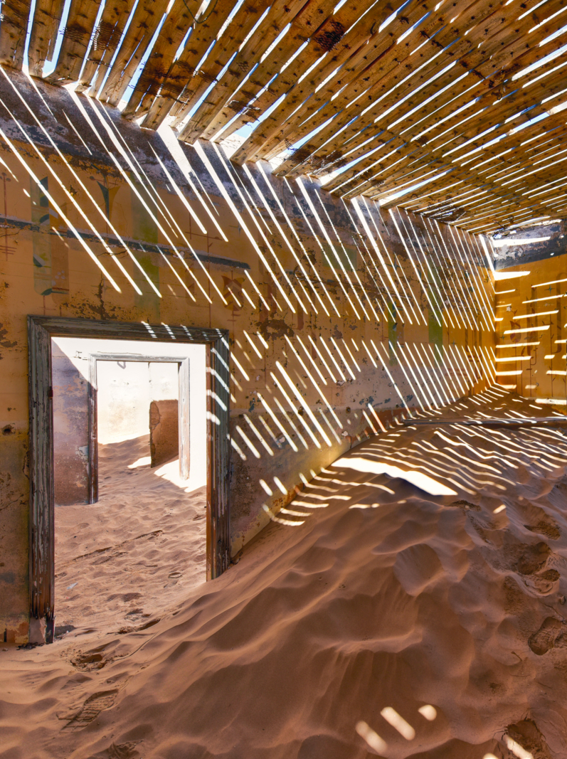 The abandoned ghost diamond town of Kolmanskop in Namibia, which is slowly being swallowed by the desert