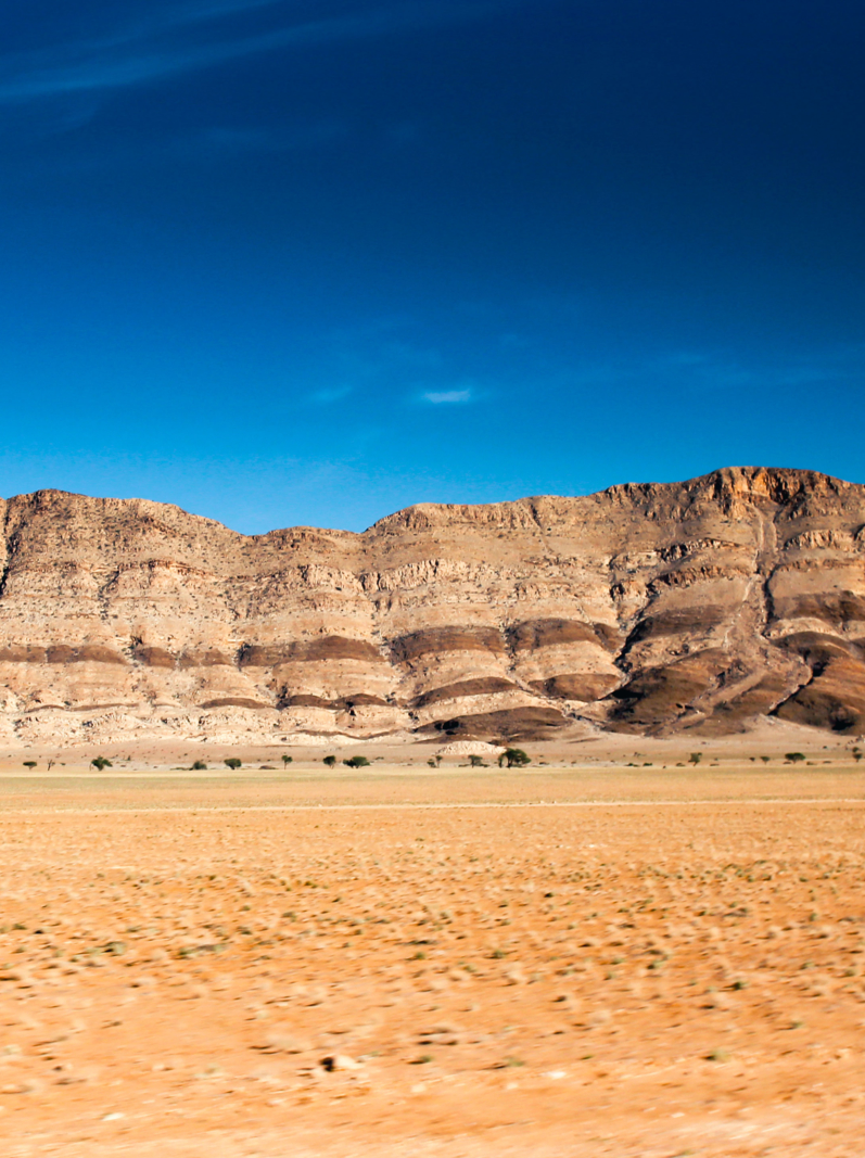 Scenic landscape of Brandberg massif in Namibia with blue sky.