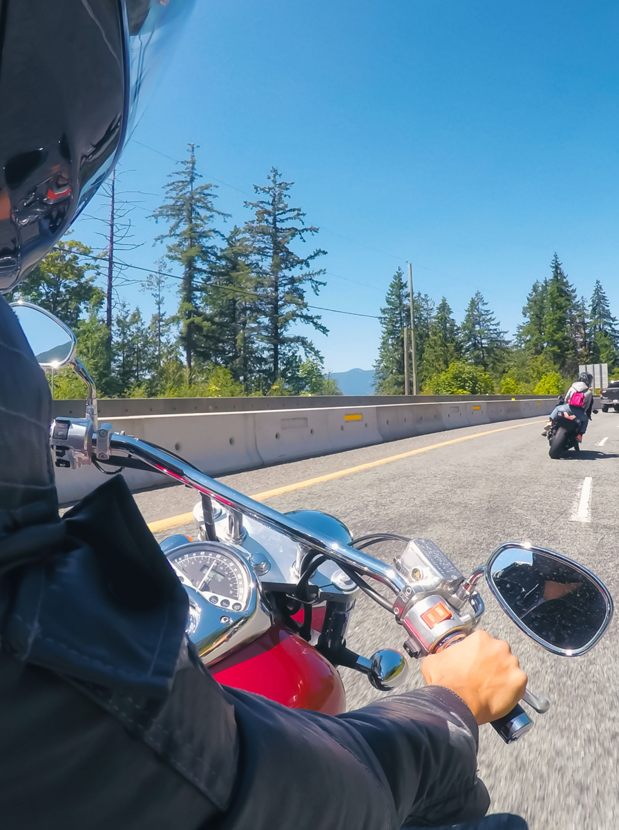 Riding on a motorcycle during a sunny summer day. Taken on Sea to Sky Highway near Squamish, North of Vancouver, BC, Canada
