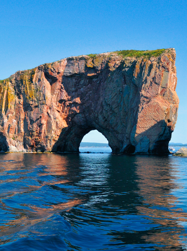 Perce Rock (French rocher Perce, "pierced rock") is a huge sheer rock formation in the Gulf of Saint Lawrence on the tip of the Gaspe Peninsula in Quebec, Canada, off Perce Bay