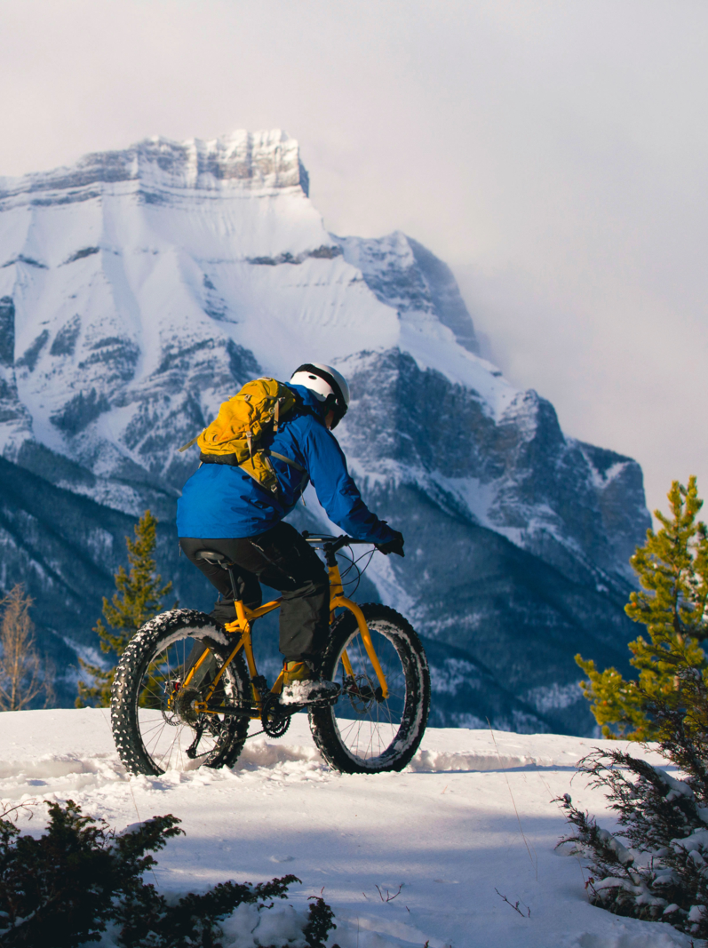 A male cyclist enjoys a winter fat bike ride in Alberta, Canada.