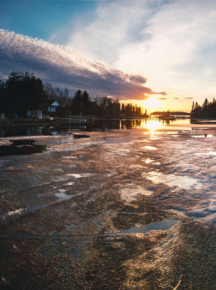 A sunset during springtime across the inlet Baie Moise with ice thawing at Lac Saint-Jean in Alma, Quebec