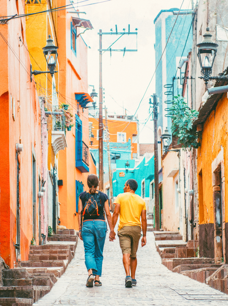 Couple walking the colorful narrow streets of Guanajuato in Mexico