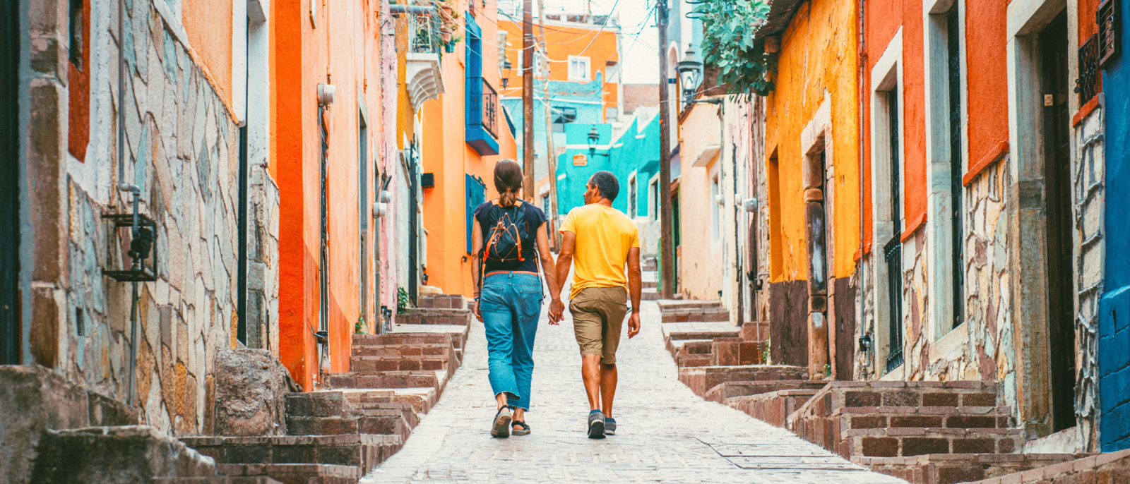 Couple walking the colorful narrow streets of Guanajuato in Mexico