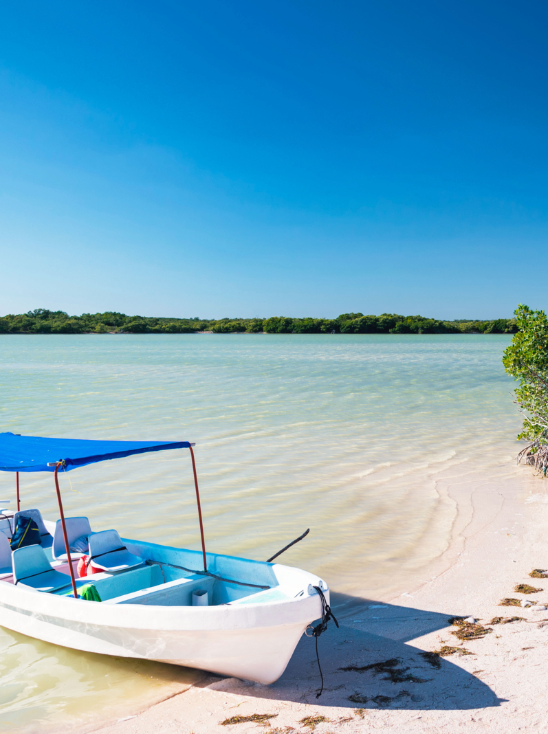 Boat on a beautiful sandy beach near Rio Lagartos, Mexico