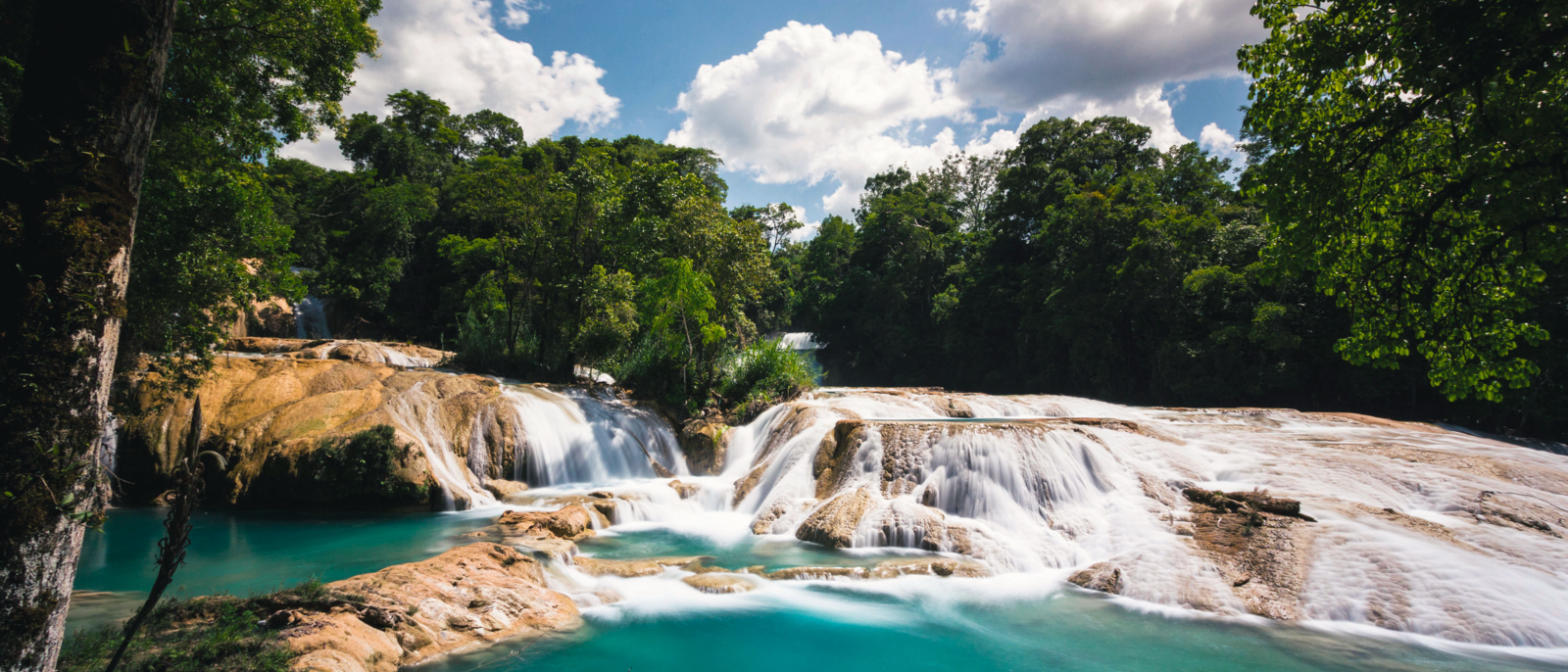 Pretty blue waterfalls of Agua Azul in Chiapas, Mexico. A place where many cataracts create many small sets of waterfalls