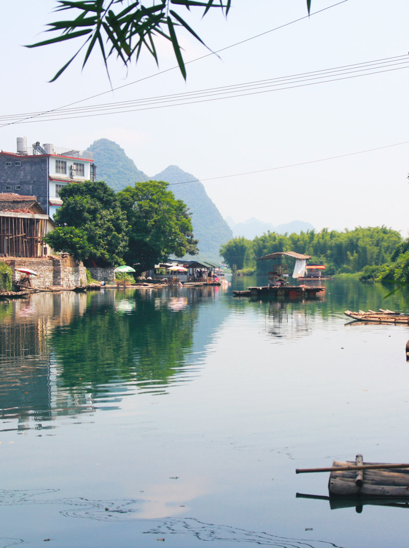 Chinese houses and bamboo rafts on Yulong river, Yangshuo county, China
