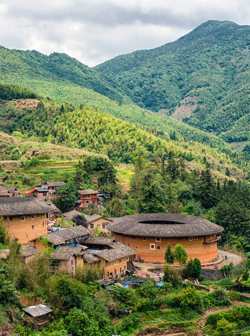 Traditional earthen Tulou Chinese huts, a landmark tourist attraction from the Fujian province of China. These large round huts are still being lived in today by the Hakka people