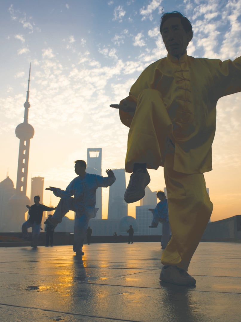 People playing Taiji on the Bund, Oriental Pearl Tower in the distance, in Shanghai, China. One of the Top Ten Shanghai Attractions