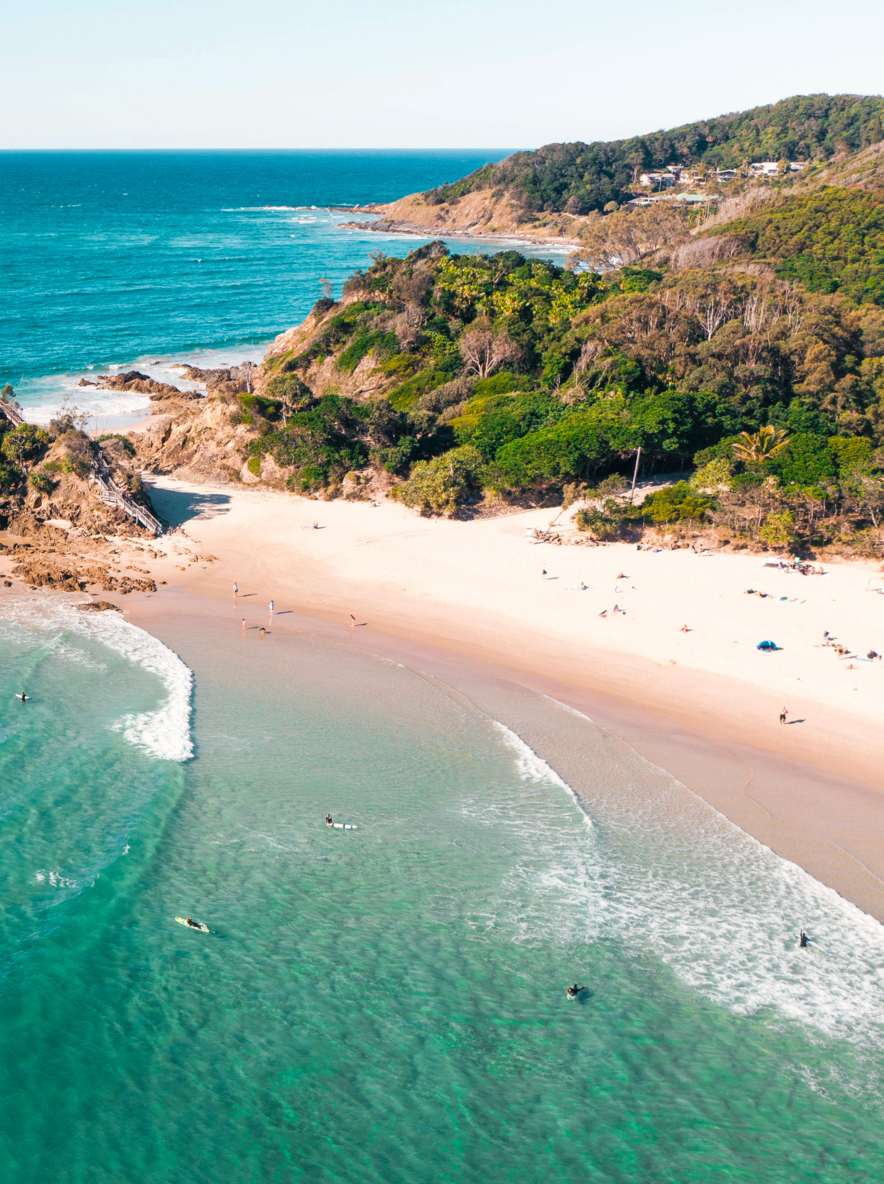 Aerial view of the pass in Byron bay during a nice afternoon with many surfers, swimmers and surfers