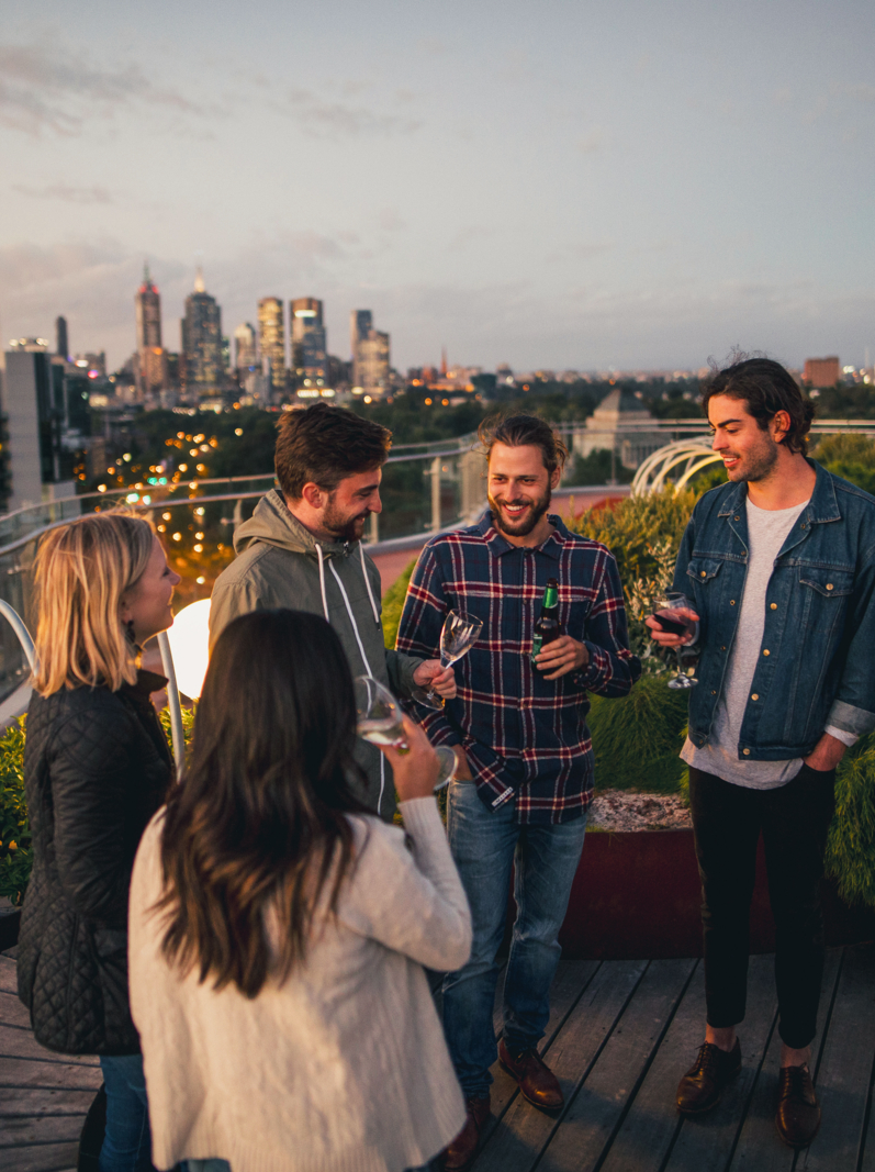 Group of friends enjoying a rooftop party in Melbourne, Australia