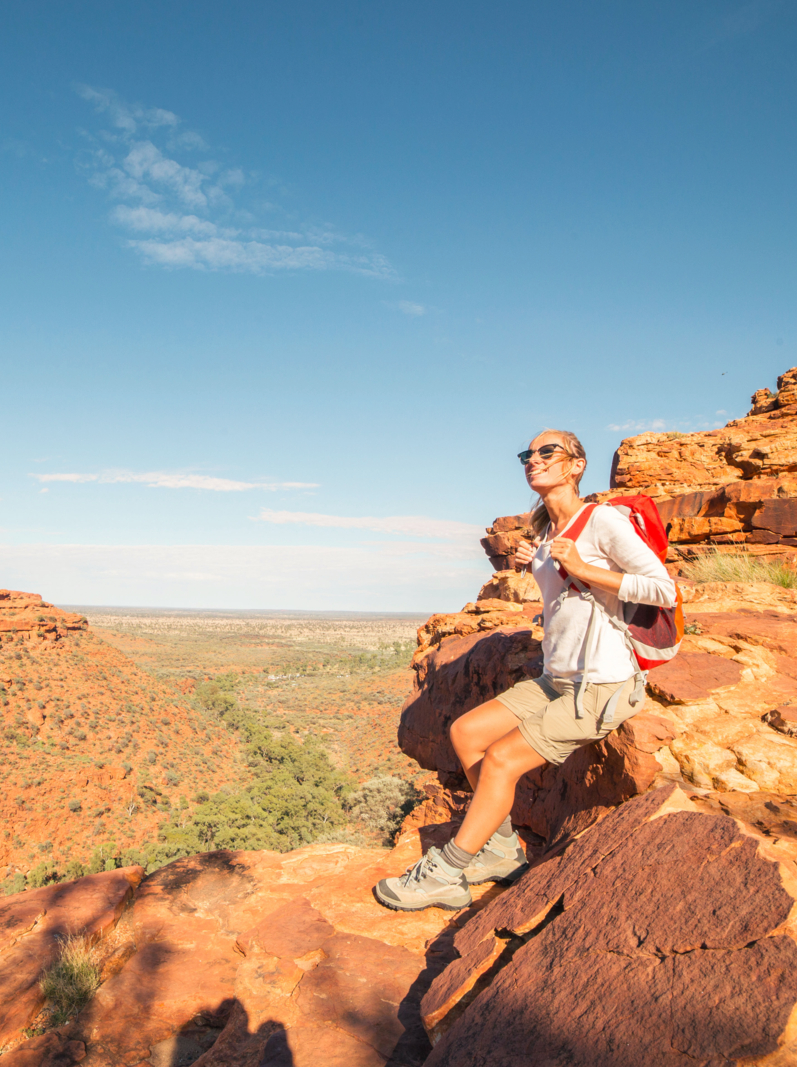 Young woman hiking in Australia contemplates the beauty in nature, landscape of kings canyon in outback, red centre of Australia.