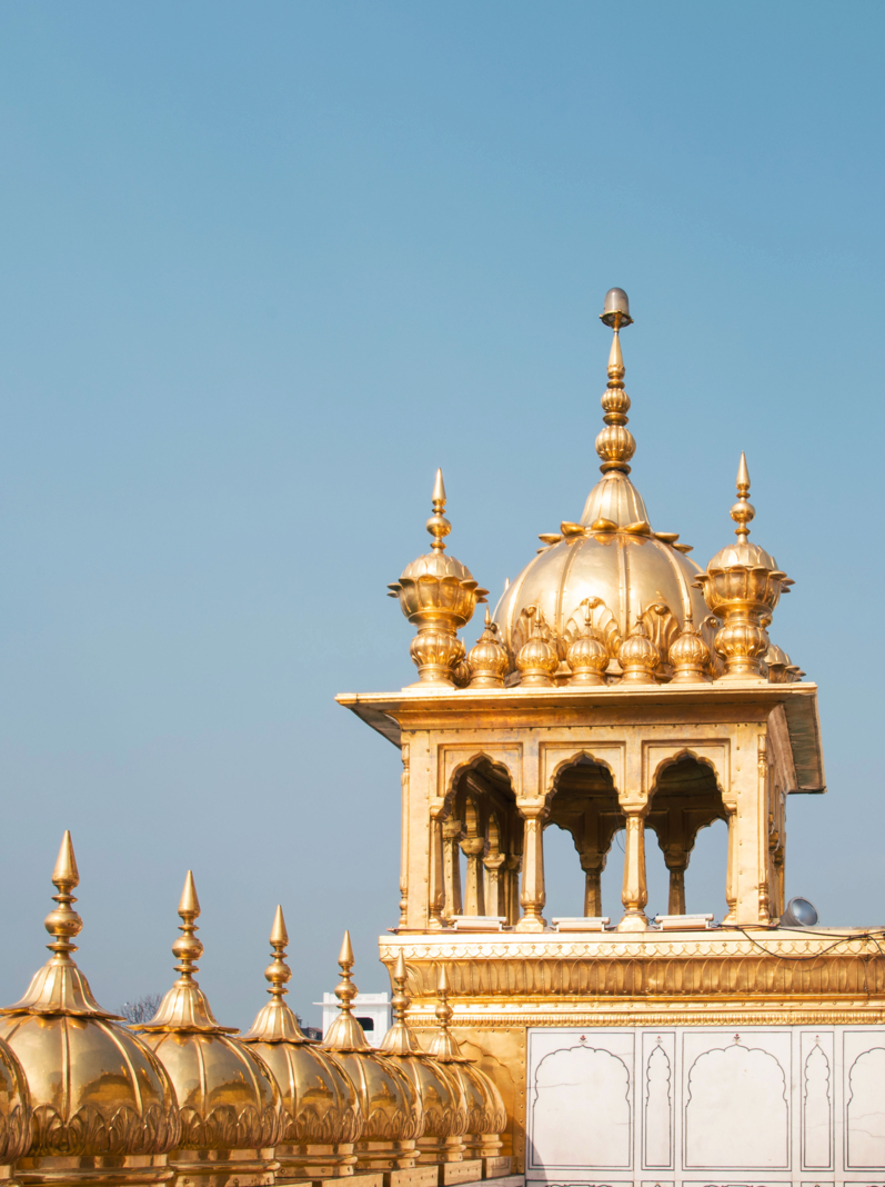 A view from the roof of the Golden Temple in Amritsar, showing the many copper gilded domes and a chhatri , or kiosk, at the corner and the side of the small square pavilion on the roof