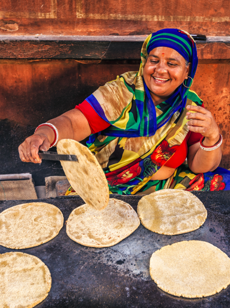 Indian street vendor preparing food - chapatti, flat bread, Jaipur - The Pink City, Rajasthan, India. Jaipur is known as the Pink City, because of the color of the stone exclusively used for the construction of all the structures.