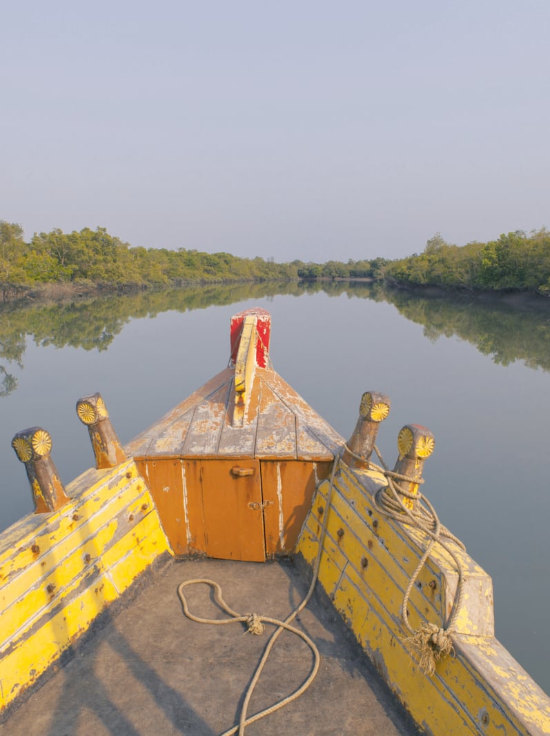 Traditional local boat sailing the Sunderbans river. India.