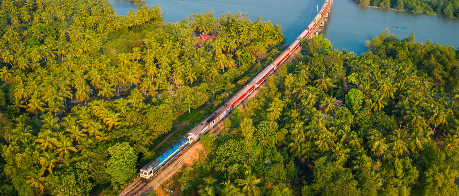 Aerial view of a passenger train crossing the Honnavar Railway Bridge across river Sharavati, in Karnataka, India
