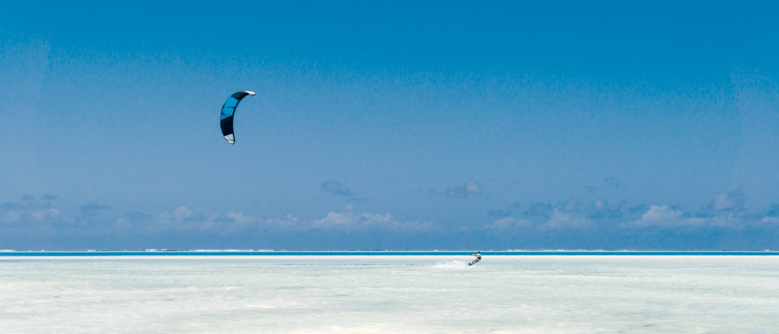 kitesurfing on tropical sea at low tide in Jambiani, Zanzibar, Tanzania Africa