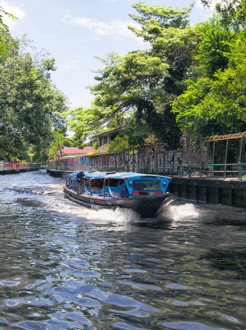 River boat transporting passengers and tourist down Chao Praya river , Bangkok , Thailand