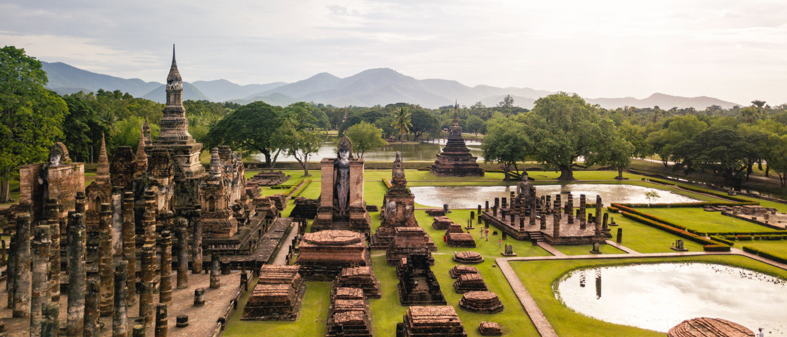 Aerial View of a historical sites ruins Buddhist Temple Wat Mahathat at The Sukhothai Historical Park, a registered UNESCO World Heritage City in the tranquil late afternoon sun