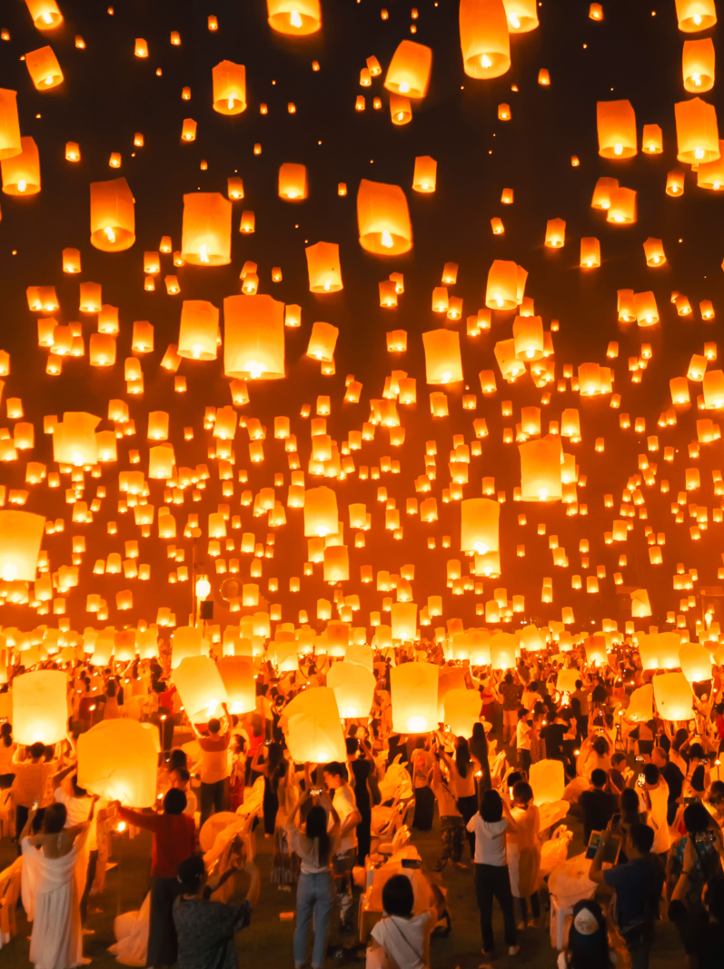 Thai people release sky floating lanterns or lamp to worship Buddha's relics at night. Traditional festival in Chiang mai, Thailand. Loy krathong and Yi Peng Lanna ceremony.