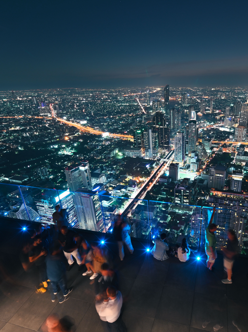 People with night 360 degree panoramic views on 78th floor at King Power Mahanakhon building.