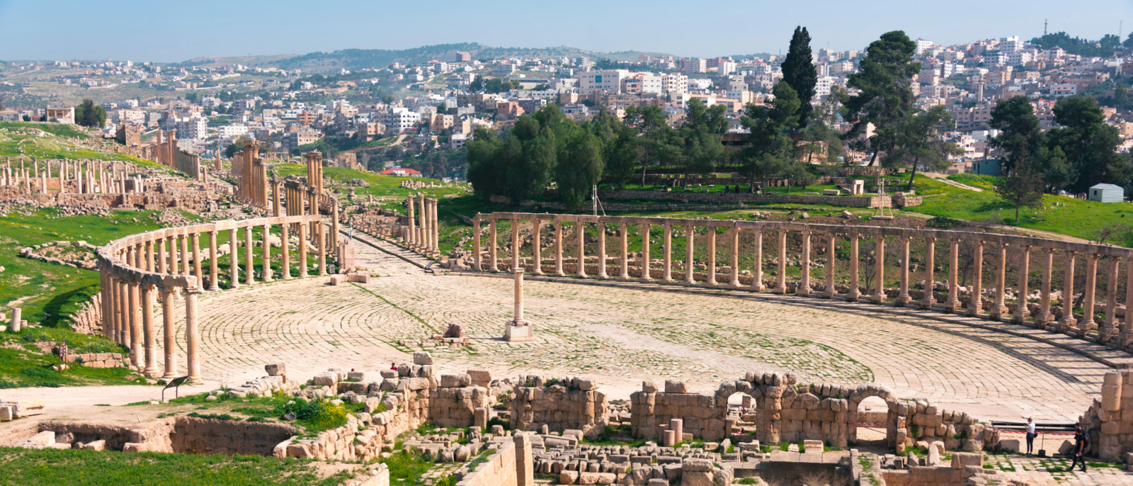 Top view on Forum or Oval Square with ruins foreground in ancient city Jerash and modern city Jerash background