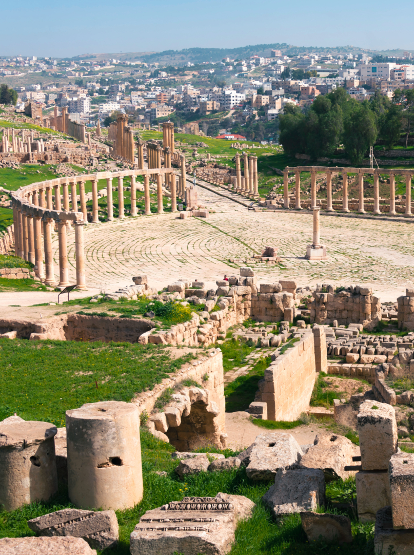 Top view on Forum or Oval Square with ruins foreground in ancient city Jerash and modern city Jerash background