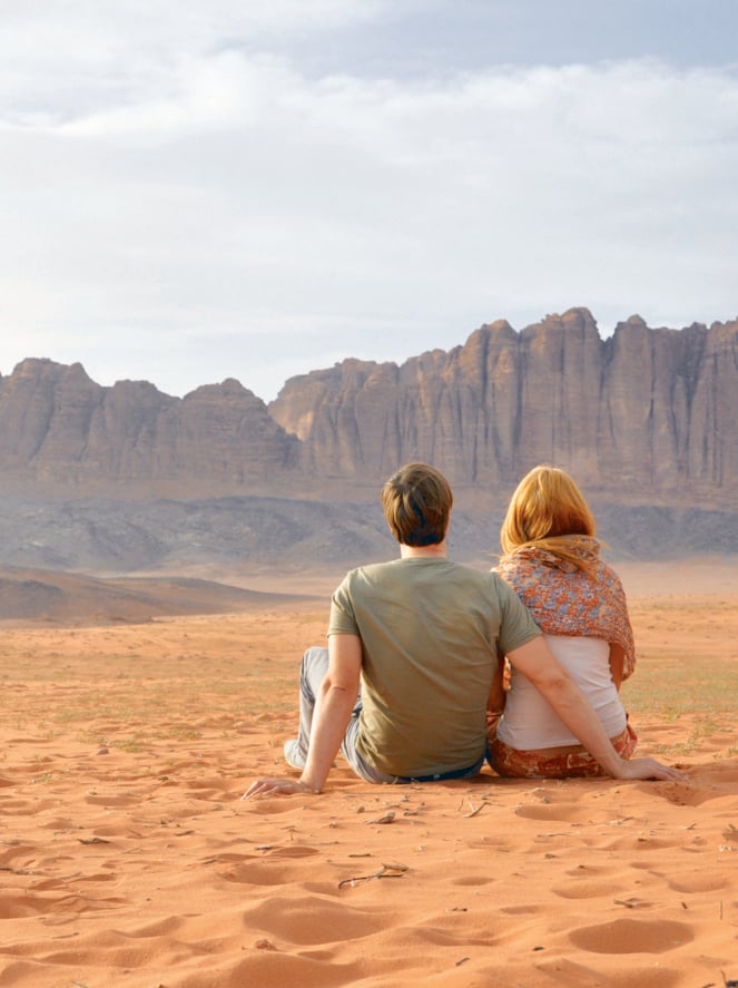 Couple sitting in Wadi rum desert