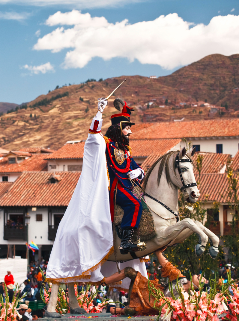 A statue of a man on horseback, one of the patron saints of a local Cuzco churches, tramples a statue of another man, likely the enemy of catholicism. Part of the Corpus Christi Catholic Religious Festival, Cuzco, Peru